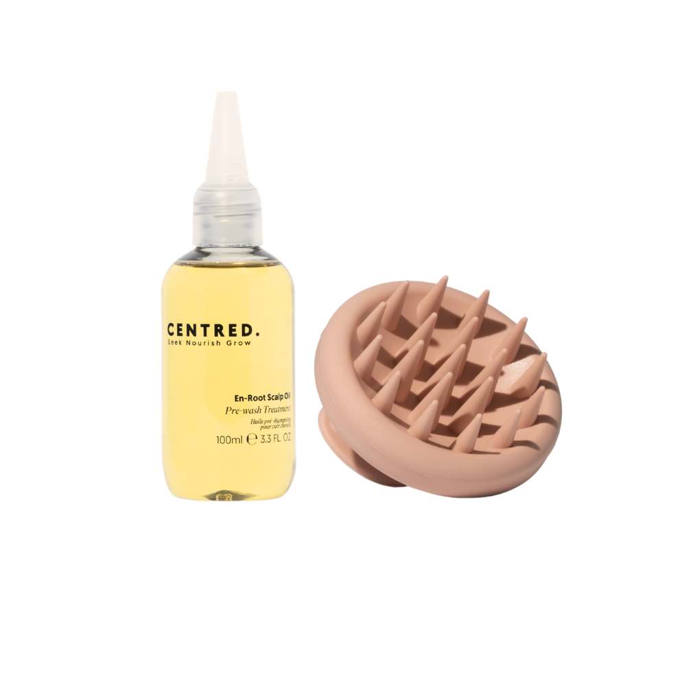 Scalp oil in clear bottle and scalp massager brush for dry flaky scalp